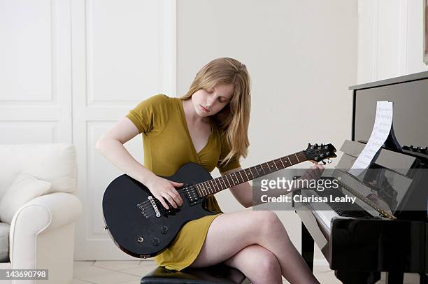 teenage girl playing electric guitar - constantia stock-fotos und bilder