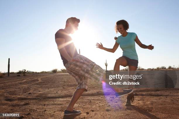 couple playing with hackey sack outdoors - playing hacky sack stock pictures, royalty-free photos & images