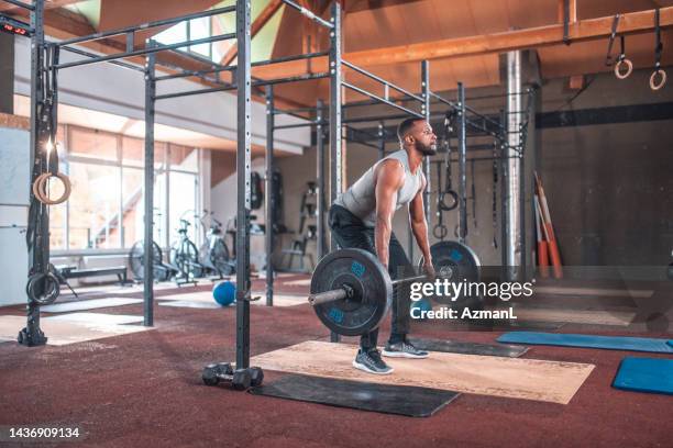 black male muscular athlete practicing deadlift with barbell - deadlift stock pictures, royalty-free photos & images