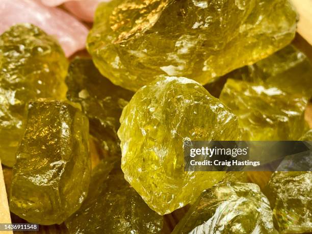 macro close up of groups of raw unprocessed natural semi-precious yellow citrine gemstone rocks - topaz stock pictures, royalty-free photos & images