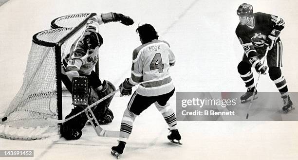 Goalie Don McLeod of the Vancouver Blazers deflects the shot by Paul Henderson of the Toronto Toros as McLeod's teammate Mike Pelyk helps on November...