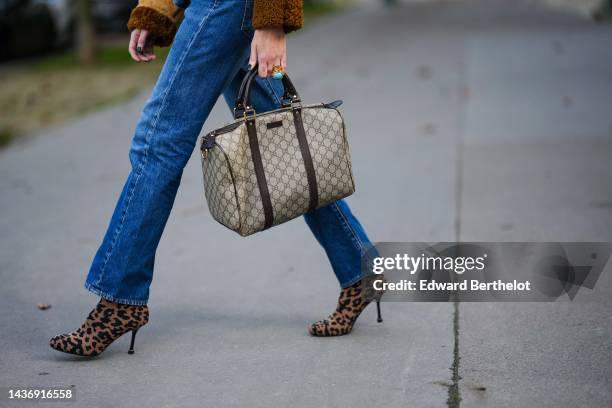 Emy Venturini wears blue cut-out / trompe l'oeil waist / ripped pants from Levis Vintage She Abbigliamento, a beige and brown GG monogram print...