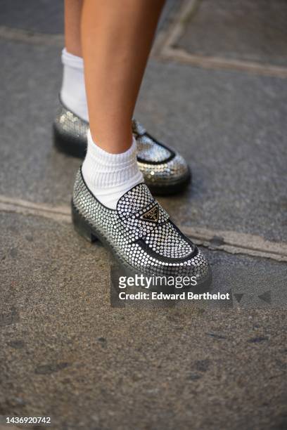 Natalia Verza wears white socks, black leather and embroidered crystal loafers from Prada , during a street style fashion photo session, on October...