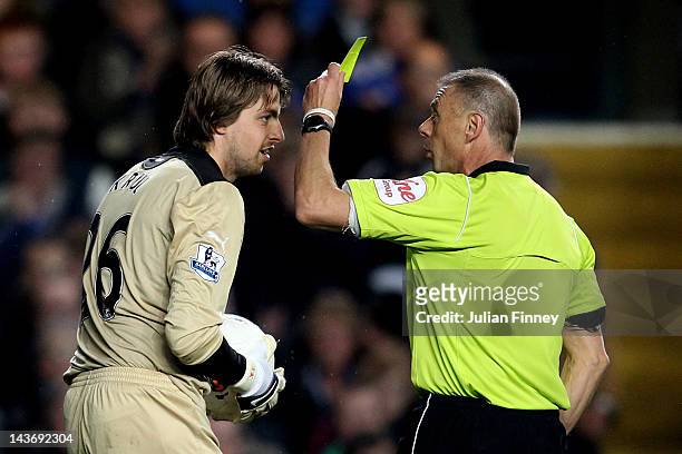 Goalkeeper Tim Krul of Newcastle is shown the yellow card by Referee Mark Halsey during the Barclays Premier League match between Chelsea and...