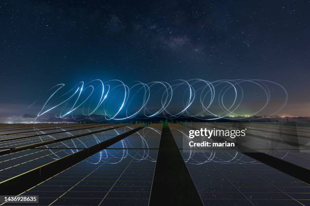 solar power plant and milky way starry sky - grünes wirtschaften stock-fotos und bilder