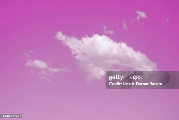 full frame of the pink sky with a white cloud. - midday stock pictures, royalty-free photos & images