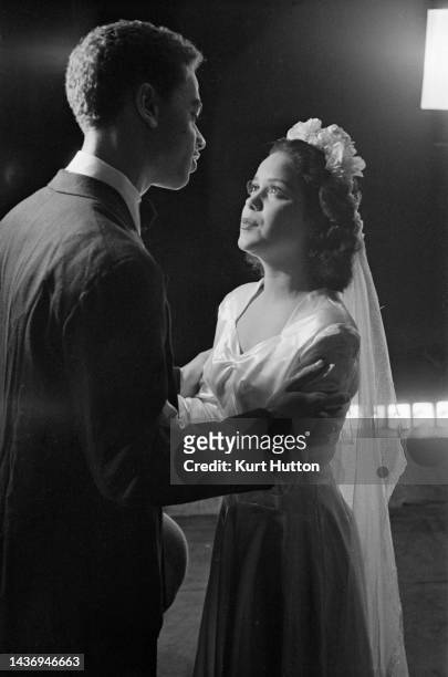 American actor Earle Hyman , who plays 'Rudolf' with American actress Hilda Simms , in the title role, in a scene from the stage production 'Anna...