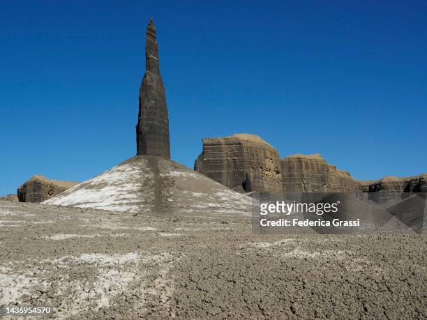 pinnacle rock formation called "the spire" or "long dong silver" at the mancos badlands, north caineville mesa, utah - pinnacle rock formation fotografías e imágenes de stock