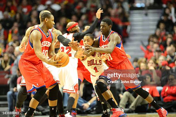 Playoffs: Chicago Bulls Derrick Rose in action, defense vs Philadelphia 76ers Jrue Holiday and Lavoy Allen at United Center. Game 1. Chicago, IL...