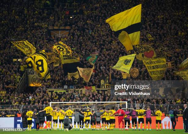 Borussia Dortmund players engage with the mass of Dortmund fans on the Yellow Wall after the UEFA Champions League group G match between Borussia...