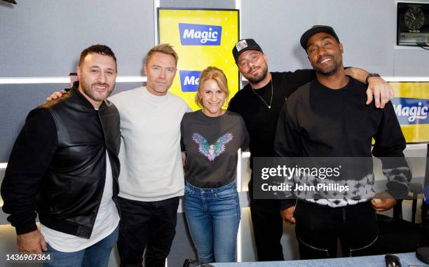 Ronan Keating, and Harriet Scott pose with Antony Costa, Duncan James and Simon Webbe of Blue on October 27, 2022 in London, England.