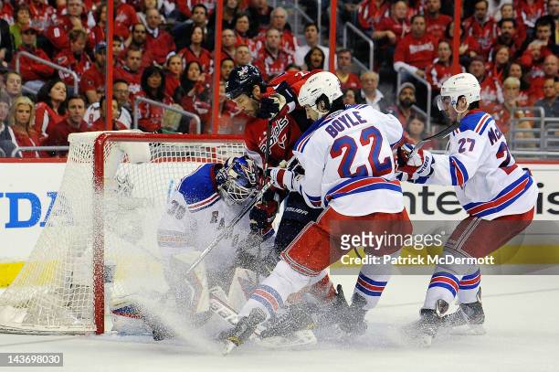 Mike Knuble of the Washington Capitals battles with Henrik Lundqvist, Brian Boyle, and Ryan McDonagh of the New York Rangers in front of the net...