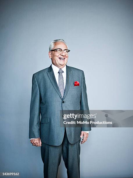 studio portrait of business man - businessman laughing stock-fotos und bilder