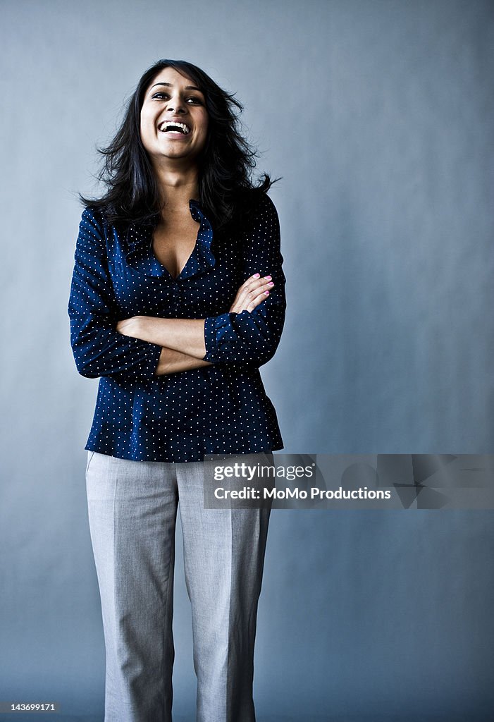 Studio portrait of woman laughing