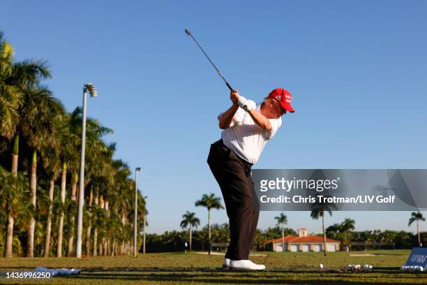 Former U.S. President Donald Trump plays a shot on the driving range during a pro-am prior to the LIV Golf Invitational - Miami at Trump National...