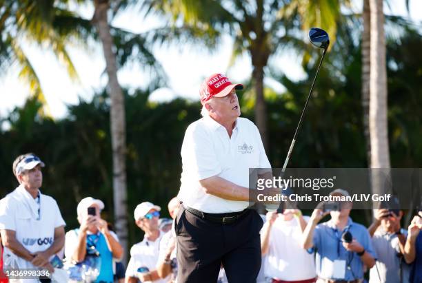 Former U.S. President Donald Trump watches his shot from the first tee during a pro-am prior to the LIV Golf Invitational - Miami at Trump National...