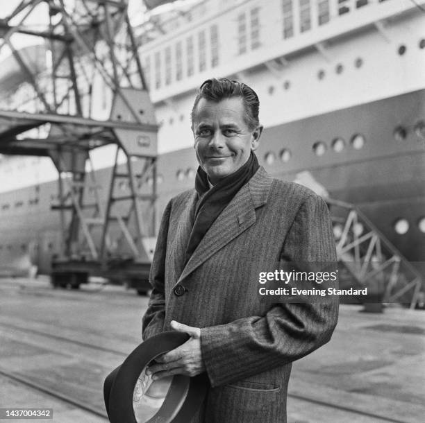 Canadian-born American actor Glenn Ford posing near an ocean liner at an unspecified location in England on September 22nd, 1960.
