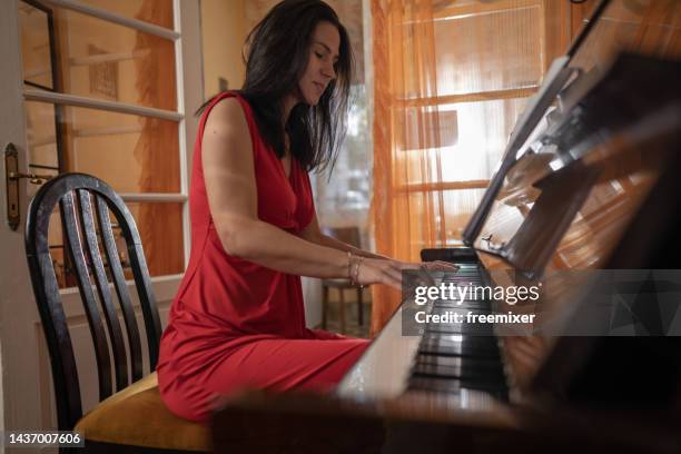 beautiful woman playing a piano - pianist imagens e fotografias de stock
