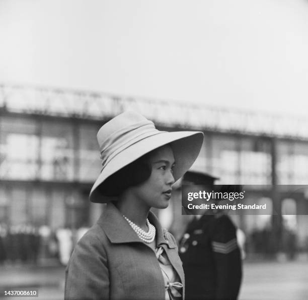 Queen Sirikit of Thailand wearing a stylish wide-brimmed hat on arrival at Gatwick Airport in London for a state visit to the United Kingdon on July...
