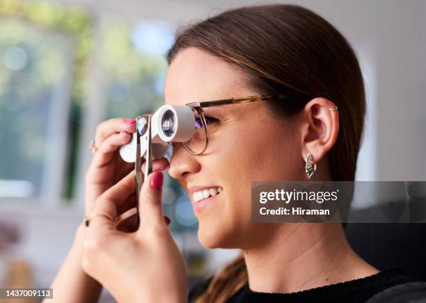 diamond appraisal, jewelry and evaluation with a woman jeweler inspecting a gemstone in a store for value. retail, eye and luxury with a female jewellery appraiser examining a precious stone - juwelier stockfoto's en -beelden