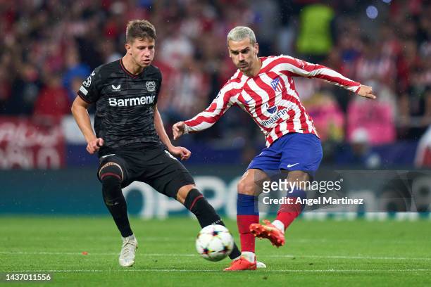 Antoine Griezmann of Atletico de Madrid is challenged by Adam Hlozek of Bayer 04 Leverkusen during the UEFA Champions League group B match between...