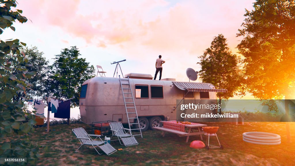 Trailer parked on camping ground in summer time