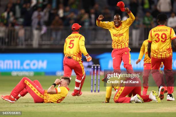 Zimbabwe celebrate defeating Pakistan during the ICC Men's T20 World Cup match between Pakistan and Zimbabwe at Perth Stadium on October 27, 2022 in...