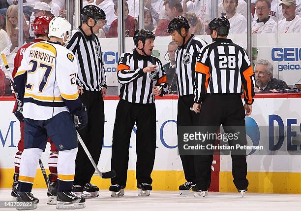 Referee Kelly Sutherland talks with linesman Jay Sharrers over a reviewed goal in Game One of the Western Conference Semifinals between the Nashville...