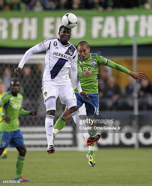 Edson Buddle of the Los Angeles Galaxy heads the ball against David Estrada of the Seattle Sounders at CenturyLink Field on May 2, 2012 in Seattle,...