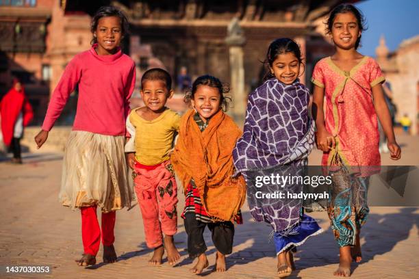 group of children crossing durbar square in bhaktapur, nepal - nepal children stock pictures, royalty-free photos & images