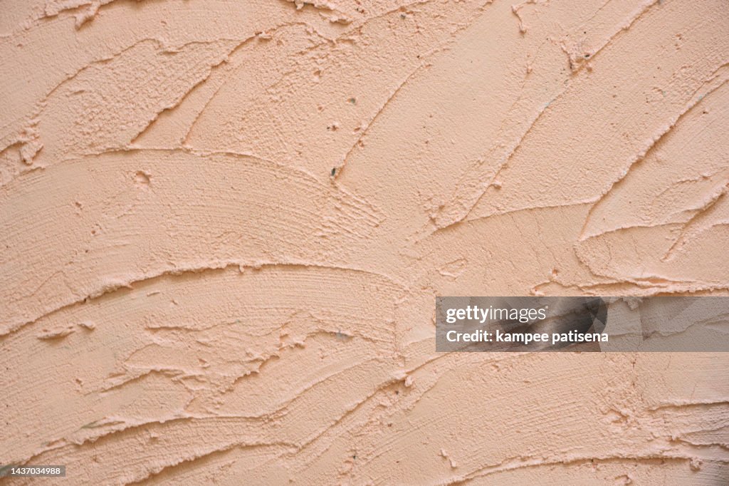 Cement wall surface texture material, peach color abstract background