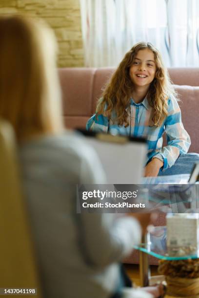 teenager girl talking with psychologist in the office - child psychologist stock pictures, royalty-free photos & images