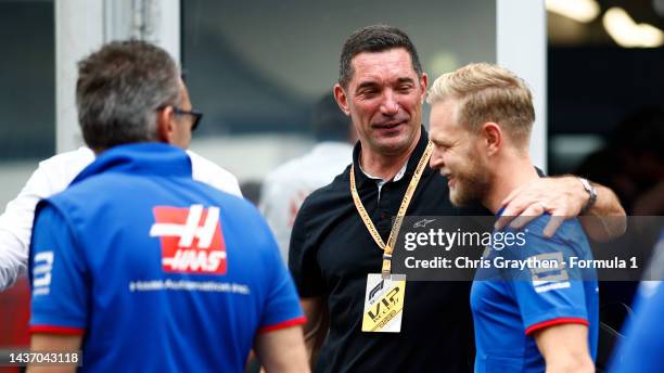 Kevin Magnussen of Denmark and Haas F1 meets Max Papis in the Paddock during previews ahead of the F1 Grand Prix of Mexico at Autodromo Hermanos...