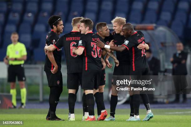 Gustav Isaksen of FC Midtjylland celebrates with teammates after scoring their side's first goal during the UEFA Europa League group F match between...