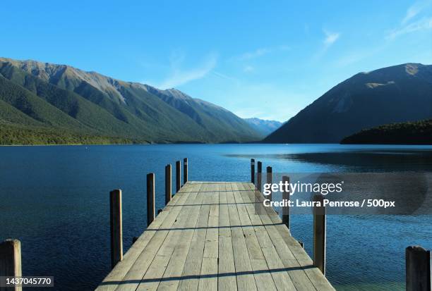 scenic view of lake and mountains against blue sky,nelson lakes national park,west coast,new zealand - summer new zealand stock-fotos und bilder
