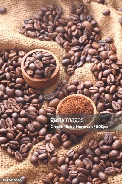 high angle view of roasted coffee beans with burlap on table,bekasi,indonesia - ground coffee stock pictures, royalty-free photos & images