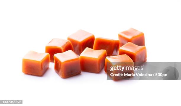 close-up of carrot slices against white background - caramel block stock pictures, royalty-free photos & images
