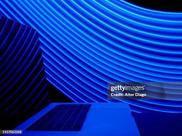laptop in a modern virtual environment. concept of trading on laptops. - dark background light stock-fotos und bilder