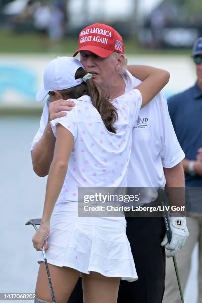 Former U.S. President Donald Trump and granddaughter Kai Trump hug on the 18th green during a pro-am prior to the LIV Golf Invitational - Miami at...