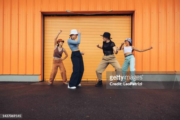 professional dancers - group of four women dancing in the streets - street fashion asian stock pictures, royalty-free photos & images