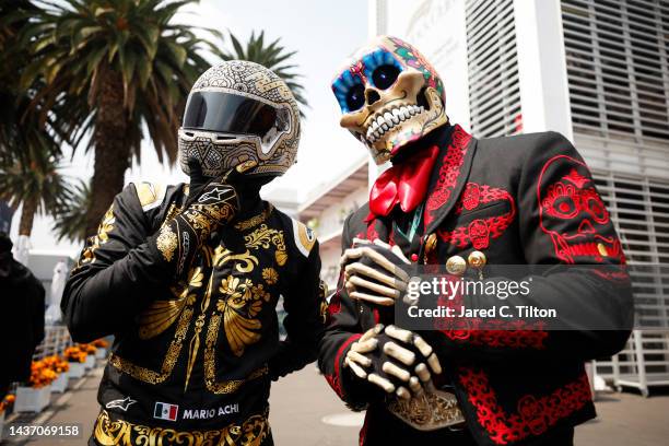 Mario Achi and a Day of the Dead performer pose for a photo during previews ahead of the F1 Grand Prix of Mexico at Autodromo Hermanos Rodriguez on...