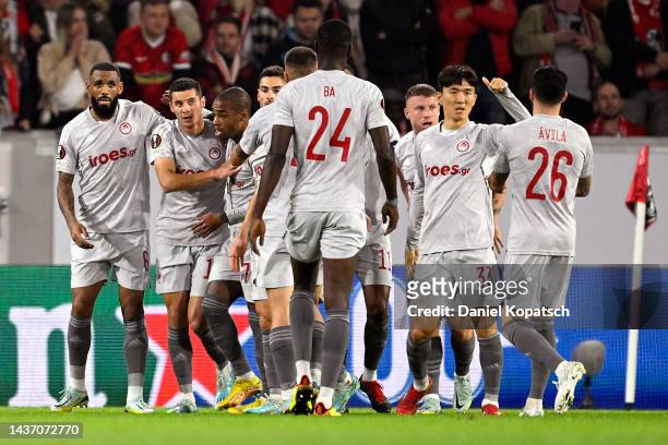 Youssef El-Arabi of Olympiacos FC celebrates with teammates after scoring their side's first goal during the UEFA Europa League group G match between...