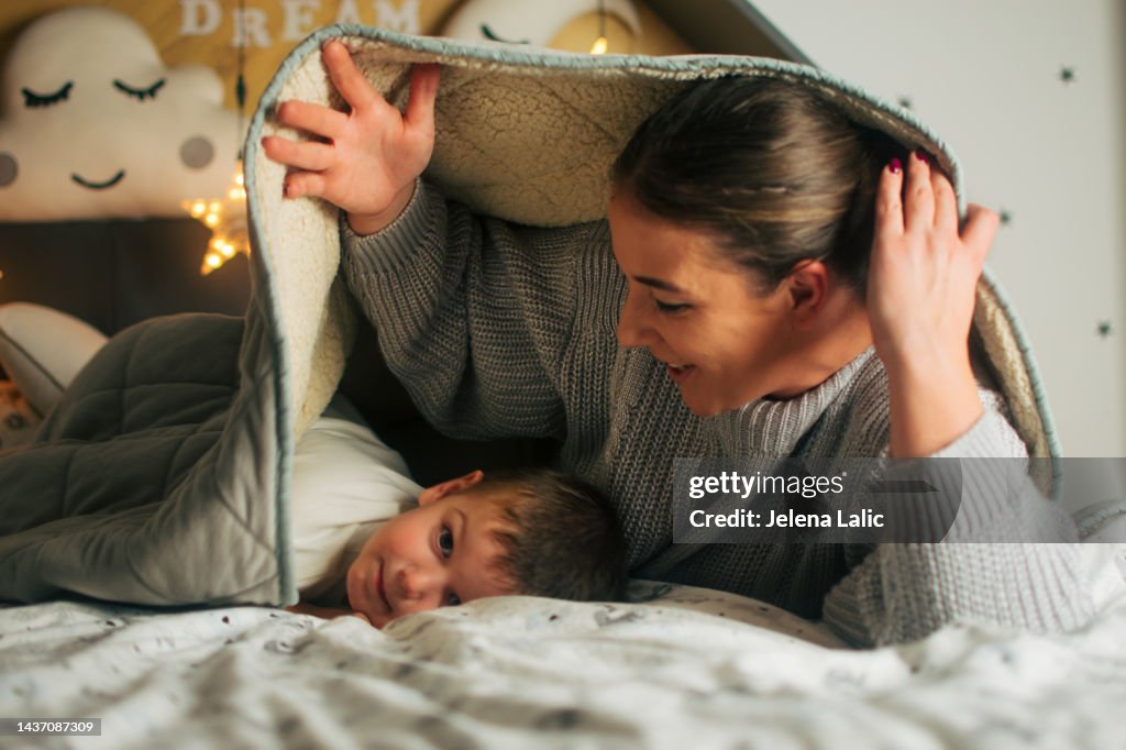 Mom and son under the duvet