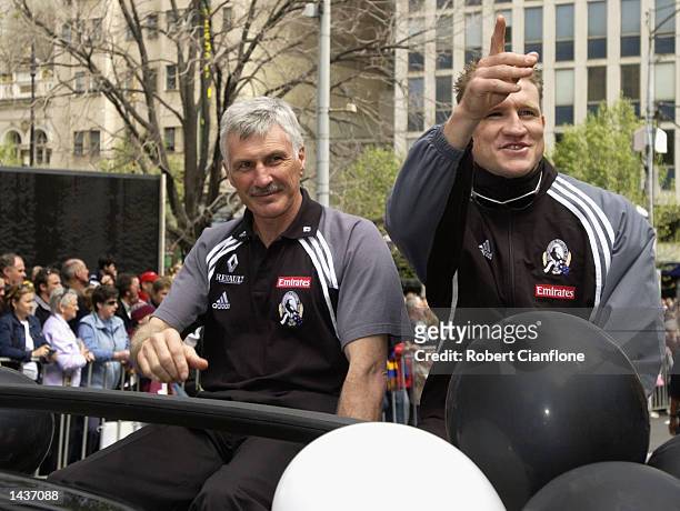 Nathan Buckley captain of the Magpies and coach Michael Malthouse waves to the fans during the 2002 AFL Grand Final Parade featuring the Collingwood...