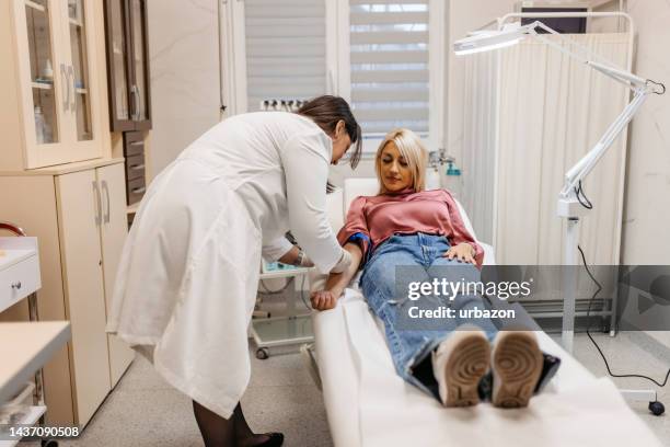 doctor taking blood samples from a female patient - test strip stock pictures, royalty-free photos & images