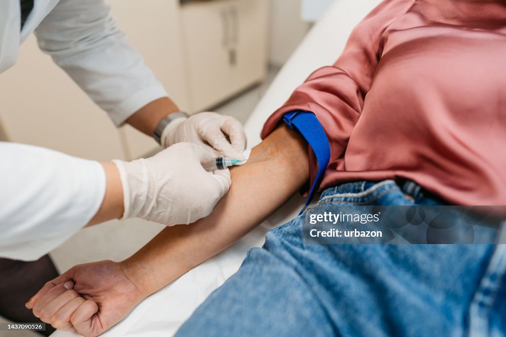 Doctor Taking Blood Samples From A Female Patient