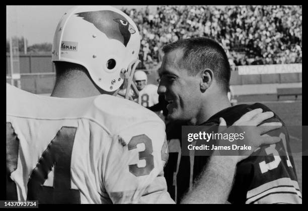 Green Bay Packers Fullback Jim Taylor chats with Cardinals Bill Koman during the St. Louis Cardinals vs Green Bay Packers NFL Football game on...