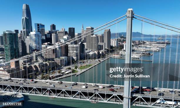 In an aerial view, cars drive by the San Francisco skyline as they cross the San Francisco-Oakland Bay Bridge on October 27, 2022 in San Francisco,...