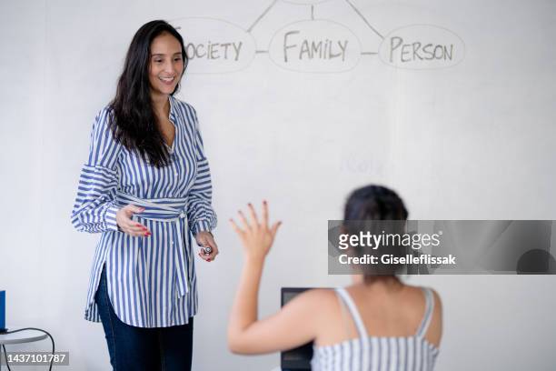 high school student raises hand and asks lecturer a question - english language bildbanksfoton och bilder