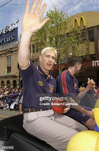 Jason Akermanis of the Lions waves to the fans during the 2002 AFL Grand Final Parade featuring the Collingwood Magpies and the Brisbane Lions held...